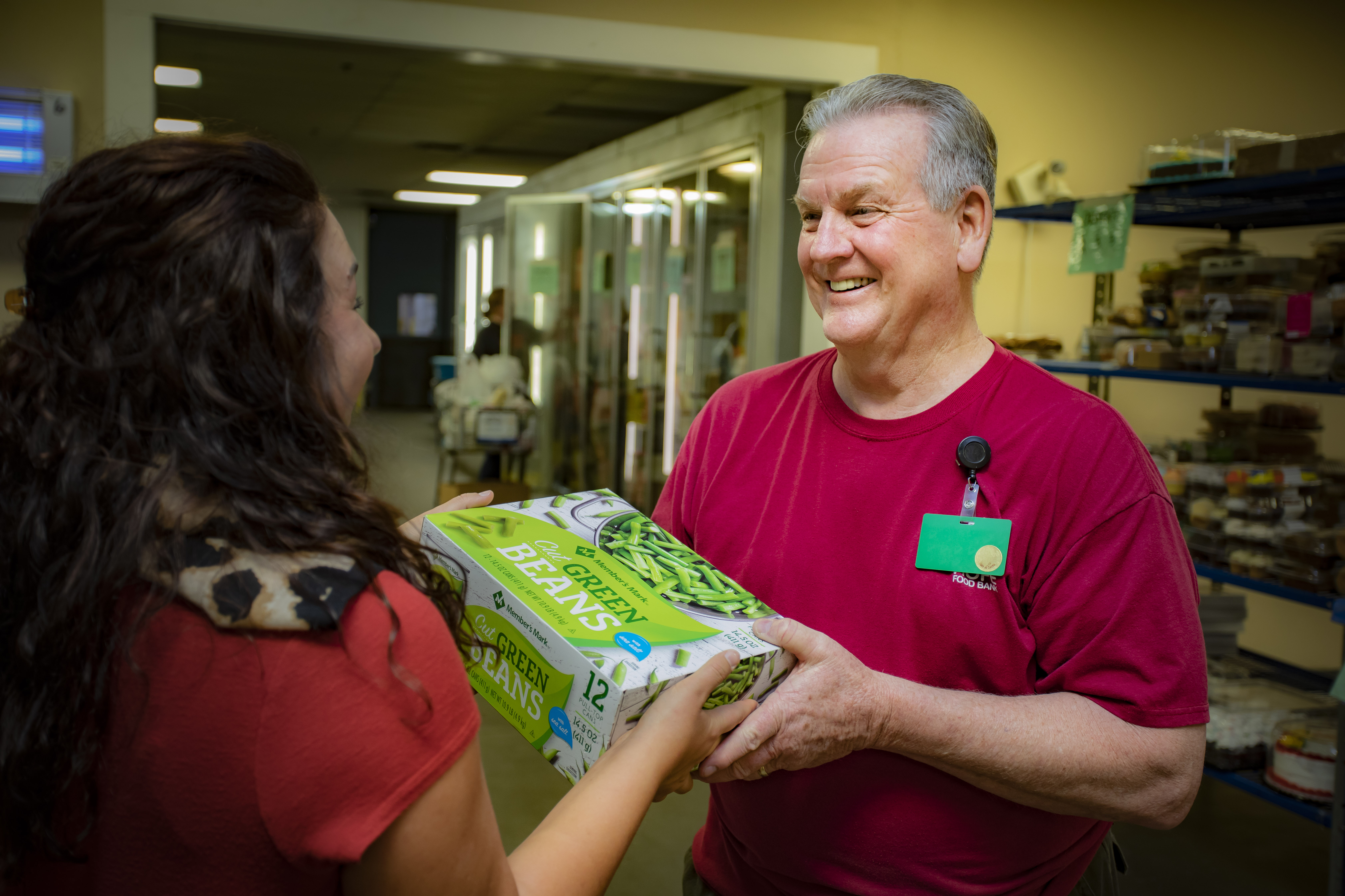 Volunteer giving food to a client